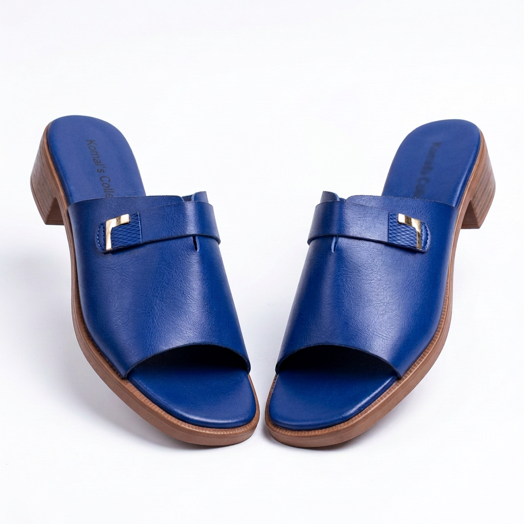 Pair of cobalt-blue women’s open-toe slides with gold-tone accents and brown block heels on white