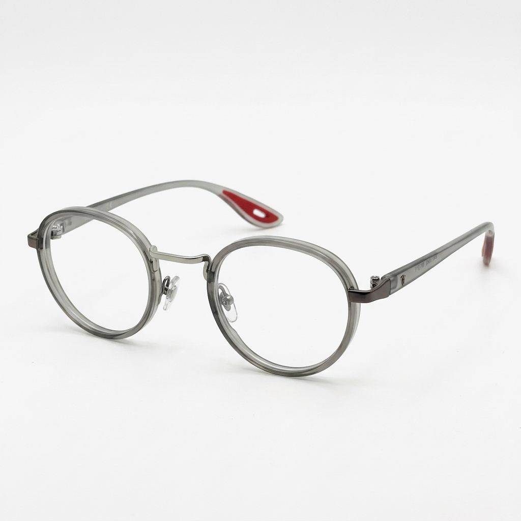 Smoky-grey rounded clear-lens eyeglasses with red temple-tip accents on white