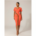 Black Nigerian model wearing the coral women’s gown with ruffle detail