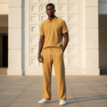 Male model wearing mustard gold chevron ribbed polo and trouser two-piece set