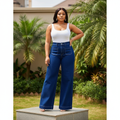 Nigerian female model wearing women's navy blue high-waist wide-leg patch pocket denim jeans, garden setting