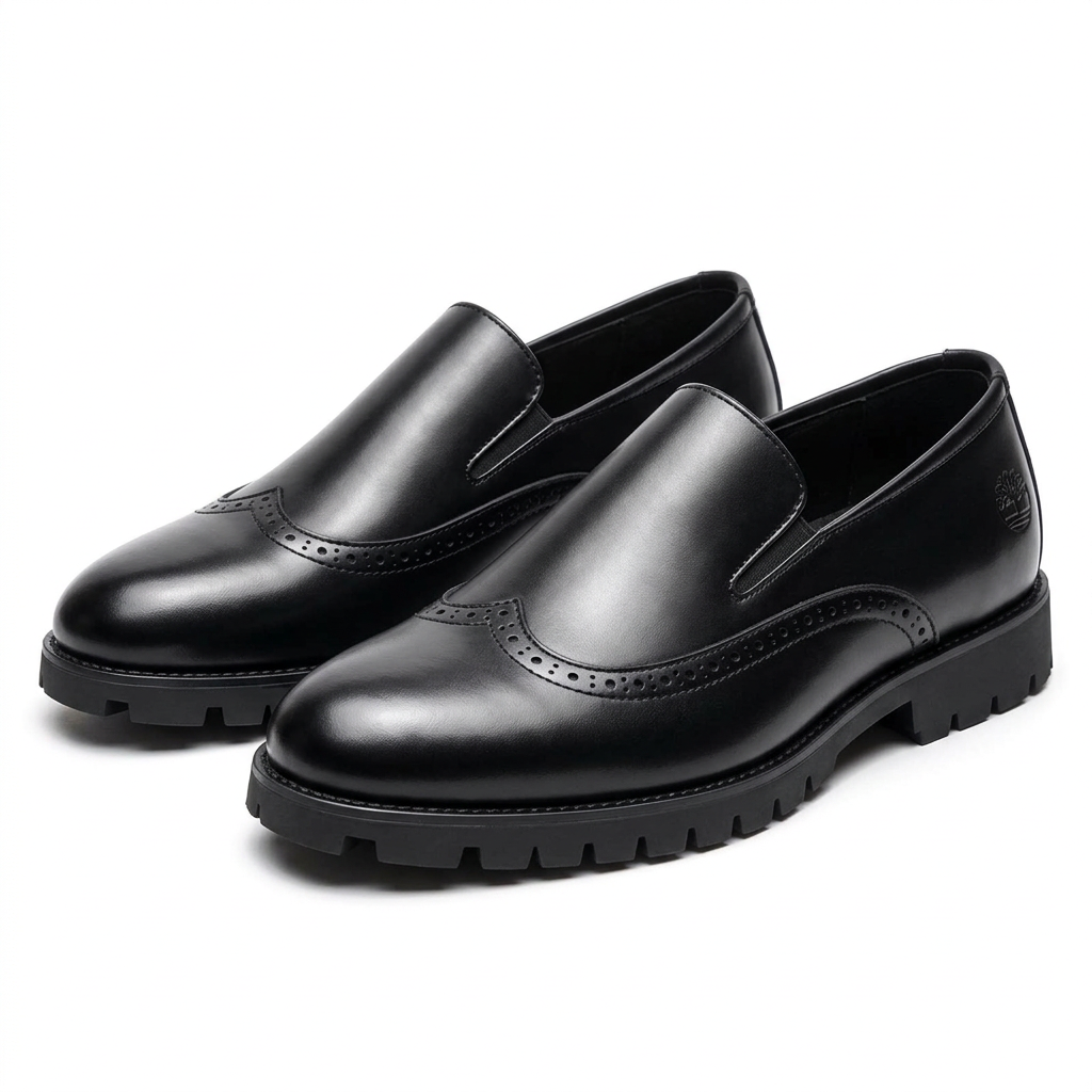 Pair of black brogue lug-sole slip-ons on a white background