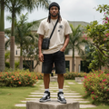 Nigerian male model wearing men's black two-tone colour-block raw hem denim shorts streetwear style