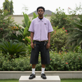 Nigerian male model wearing lavender pinstripe zip-up varsity shirt – full body lifestyle shot