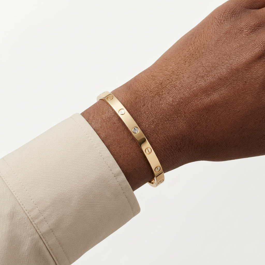 Gold-colour screw-detail bracelet worn on a Black adult wrist