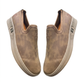 Pair of taupe perforated-toe slip-on shoes on white background