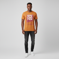 Young Nigerian male wearing burnt orange Reconnect Elements of Value graphic tee