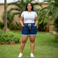 Nigerian female model wearing navy blue drawstring cuffed denim shorts - front view