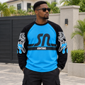 Black Nigerian adult model wearing a blue and black graphic long-sleeve shirt