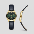 Gold-tone watch with dark green sunray dial and navy textured strap shown from the front and side