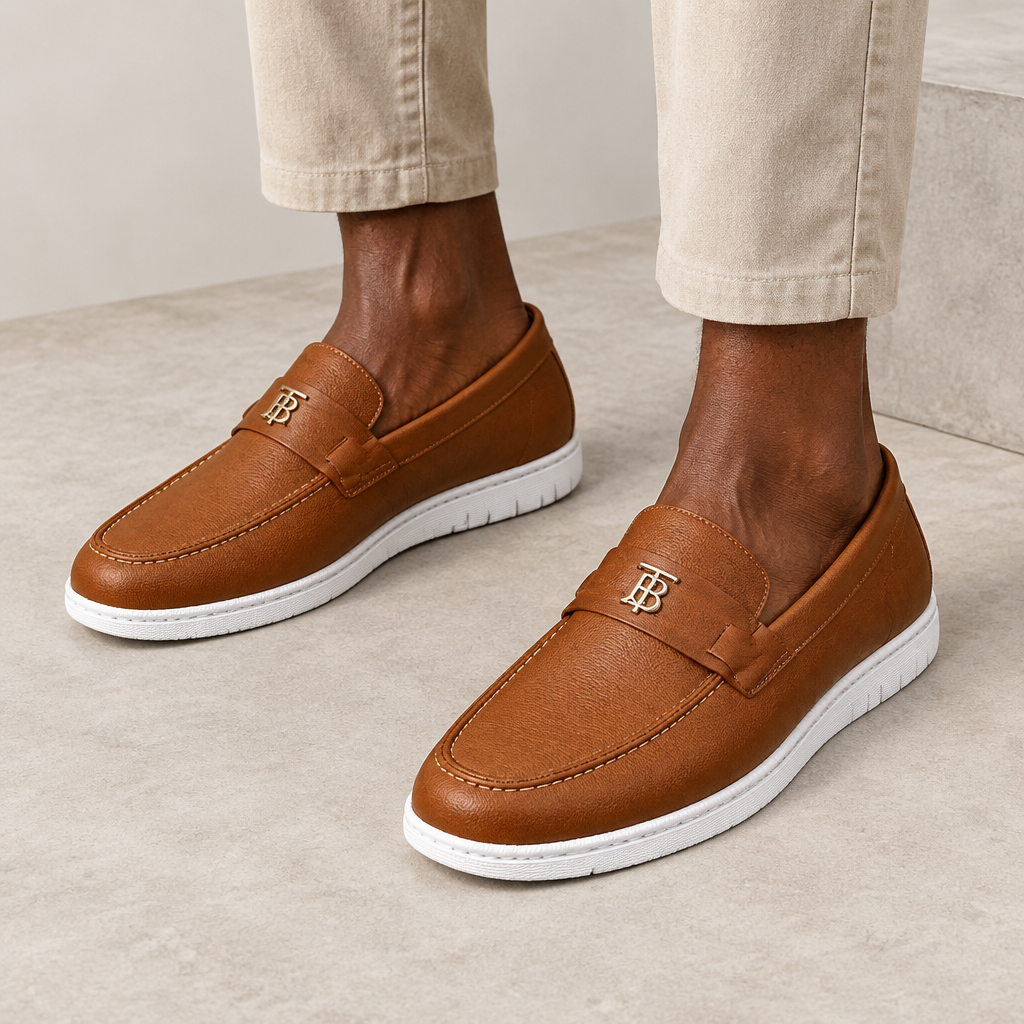 Brown buckle-detail loafers worn on both feet