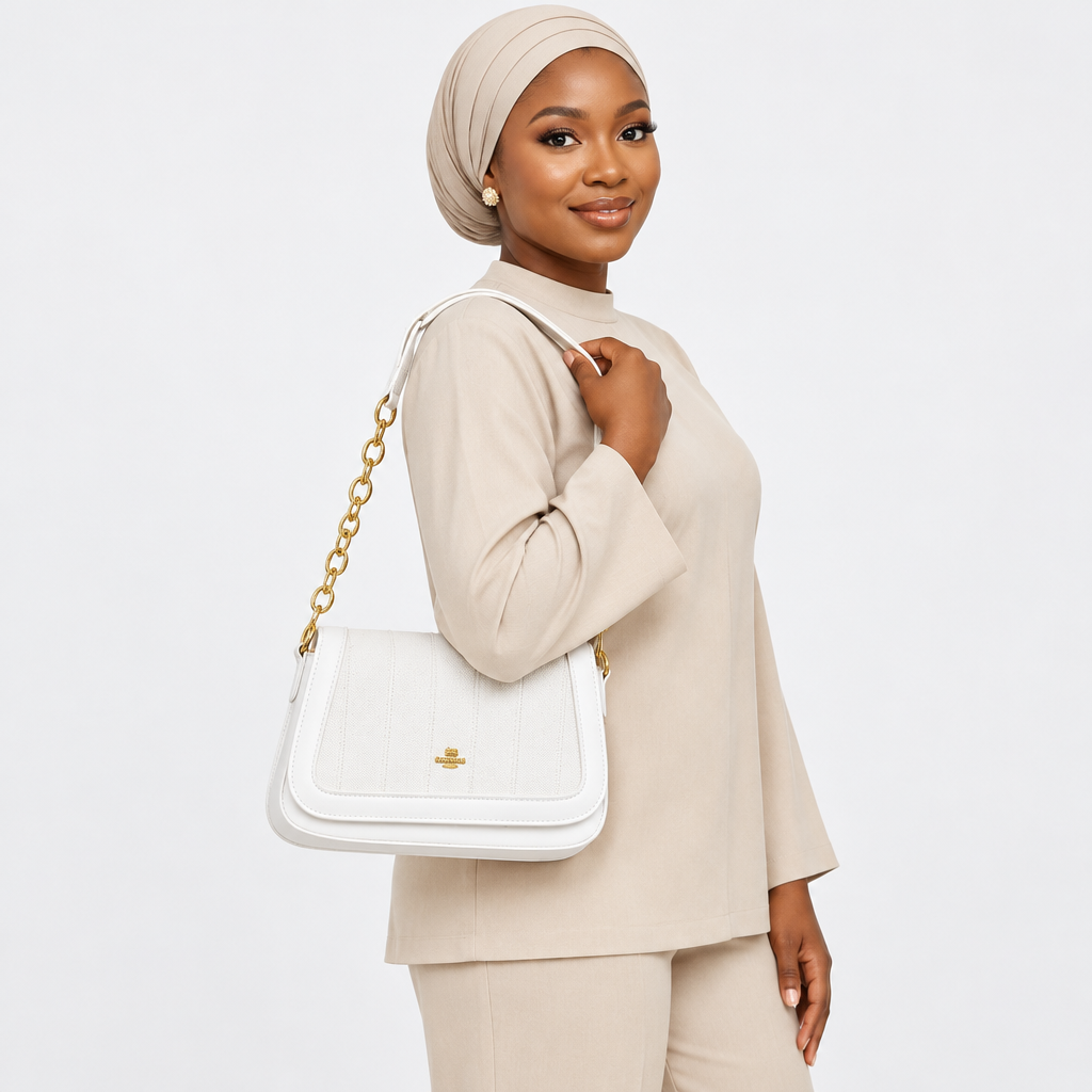 Adult woman carrying a white textured flap shoulder bag
