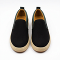 Straight-on black green-trim slip-on sneakers with ribbed cream soles