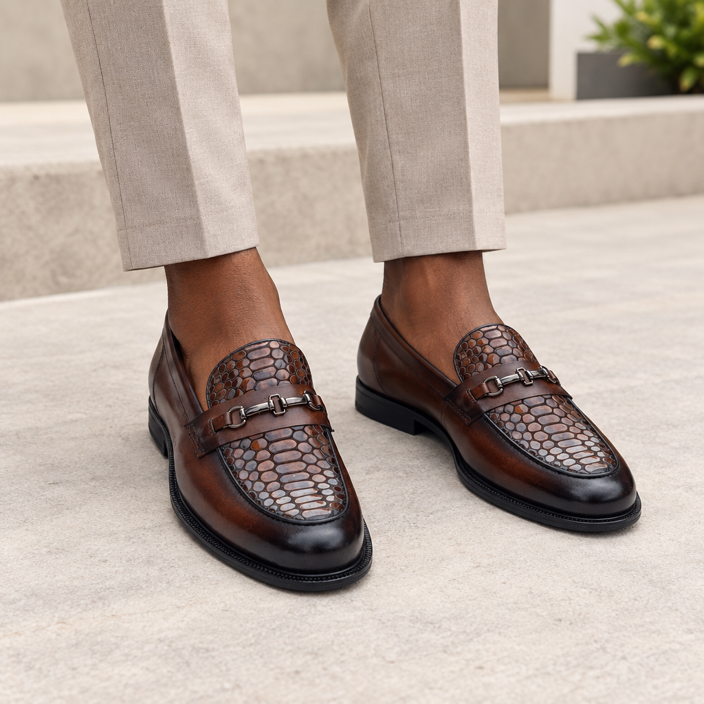 Black model wearing dark brown men's embossed-texture buckle loafers