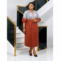 Nigerian woman wearing grey and rust ombre embroidered top and pleated midi skirt set