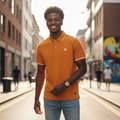 Young Nigerian male model wearing orange tipped collar polo shirt