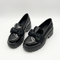 Complete matching pair of black glossy bow chunky-sole loafers