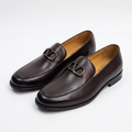 Pair of espresso-brown metal-detail loafers on white