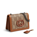 Cognac-trim taupe oval-pattern chain flap bag and separate charm on white