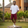 Nigerian male model wearing men's burgundy wine red wide-leg denim shorts streetwear style