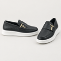 Men's black textured loafers with gold-tone bar hardware and white soles