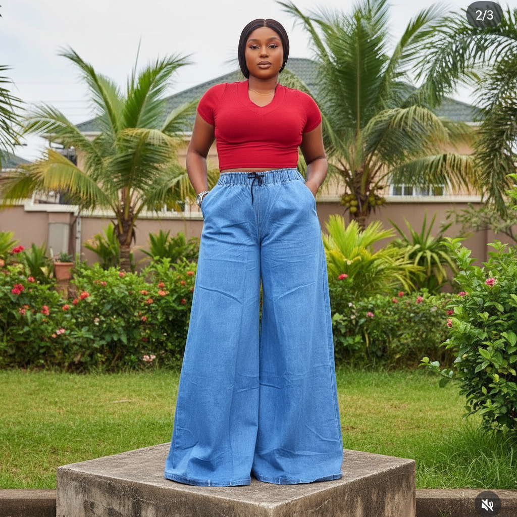 Nigerian female model wearing women's light blue wide-leg palazzo drawstring denim jeans, garden setting