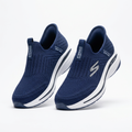 Pair of navy knit slip-on sneakers with white sculpted soles