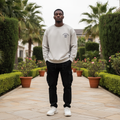 Nigerian male model wearing light grey sweatshirt with gothic arch lettering and number 17 chest graphic – front view