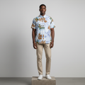 Nigerian male model wearing blue tropical leaf print short-sleeved shirt
