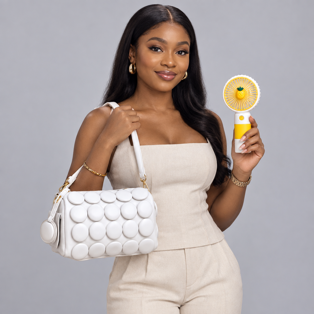Nigerian woman carrying white circle-appliqué shoulder bag and holding yellow handheld fan