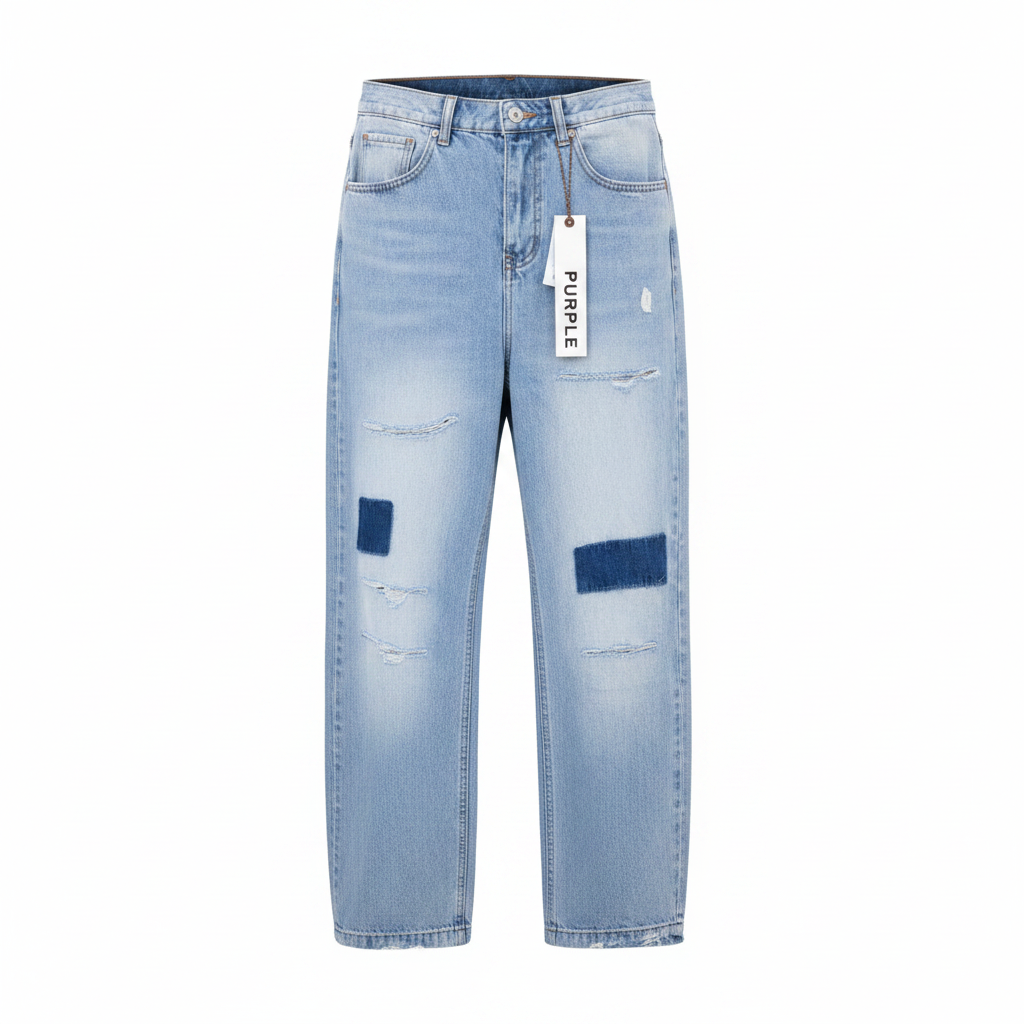 Men's light blue wide-leg baggy denim jeans with navy blue patch appliqués and distressing, ghost mannequin front view