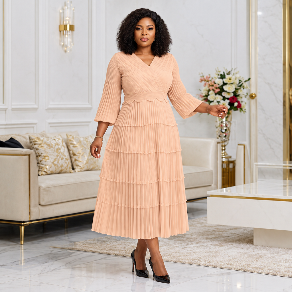 Black Nigerian woman wearing peach tiered pleated occasion dress