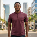 Young Nigerian male model wearing burgundy polka dot pocket polo shirt