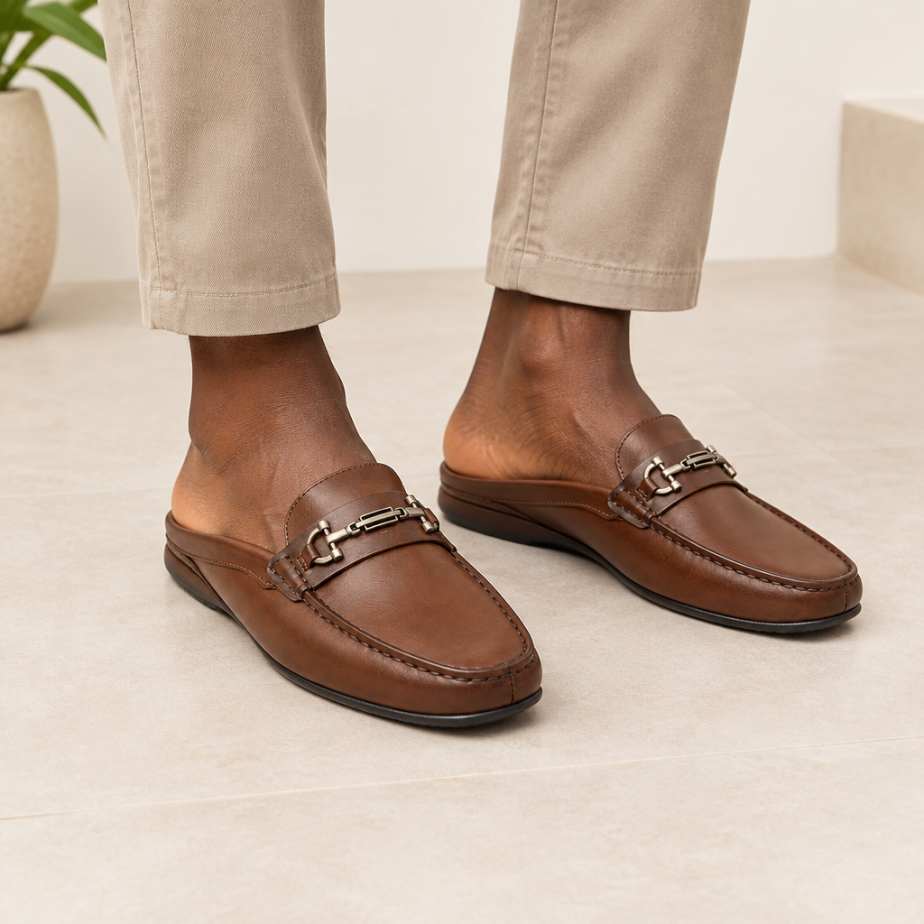 Black Nigerian adult wearing men’s brown open-back buckle slippers