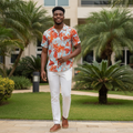 Young Nigerian male wearing sky blue tropical monstera leaf print Hawaiian short sleeve shirt