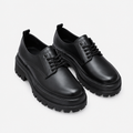 Black men's lace-up derby shoes with lug sole shown as a complete pair
