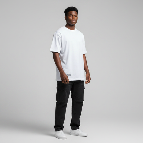 Young Nigerian male wearing white Las Vegas Raiders Established 20 graphic tee