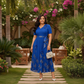Nigerian female model wearing Women's Royal Blue Gold Floral Pleated Midi Dress