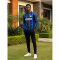 Royal blue and black striped long-sleeve retro football jersey — Nigerian male model front view