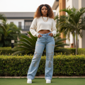 Women's light blue wide-leg flare jeans with sequin palm embellishment — Nigerian female model lifestyle shot