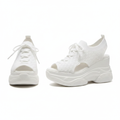 Pair of all-white peep-toe knit wedge sneakers with lace-up detail and chunky wedge sole on white background