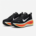 Black lace-up sneakers with red-and-yellow sculpted sole detailing