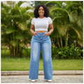 Nigerian female model wearing blue panel seam wide-leg flare jeans - front view
