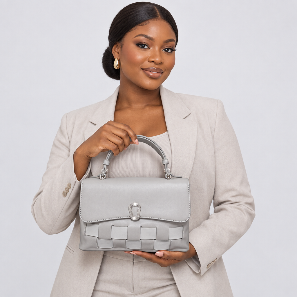 Model holding light grey woven-panel handbag