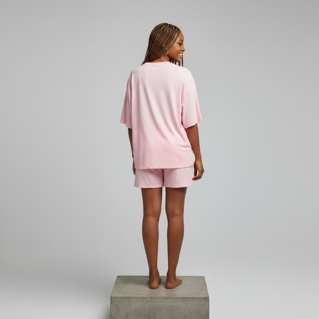 Nigerian female model back view plain - pink daisy appliqué rhinestone top and shorts set
