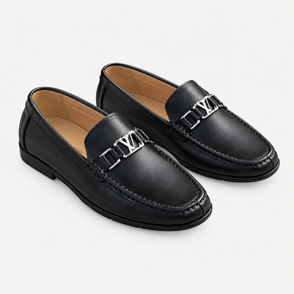 Black men's loafers with polished metal detail shown as a complete pair