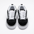 Front view of black and white low-top sneaker pair with contrast stitching
