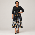 Black Nigerian model wearing a black pleated gown with floral waist detail and abstract-print skirt
