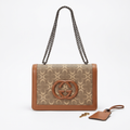 Brown-trim taupe patterned flap bag with chain strap and separate charm on white