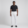 Full-body male model wearing white drawstring trousers